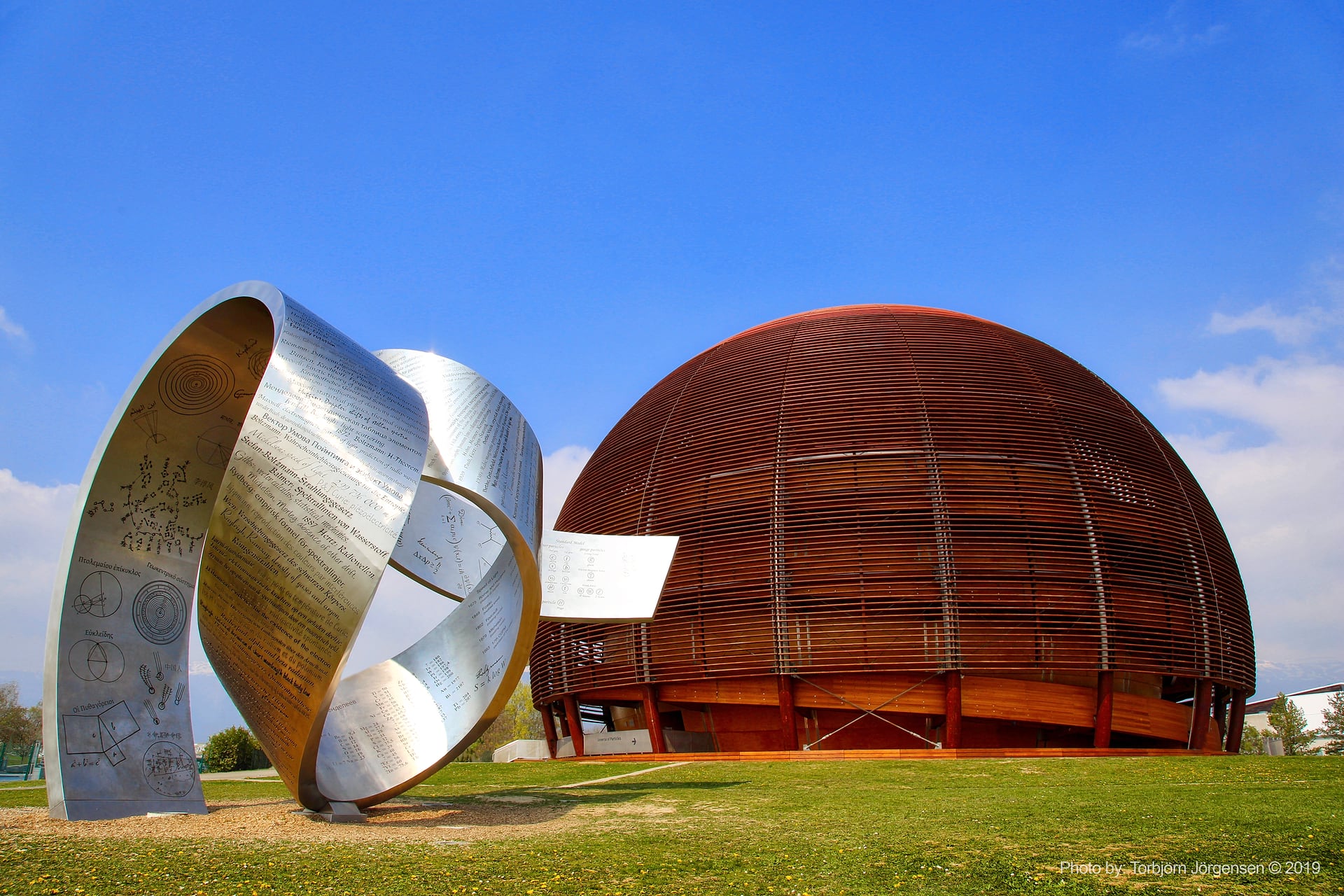 CERN's Globe of Science and Innovation in Geneva, with the sculpture Wandering the Immeasurable in the foreground