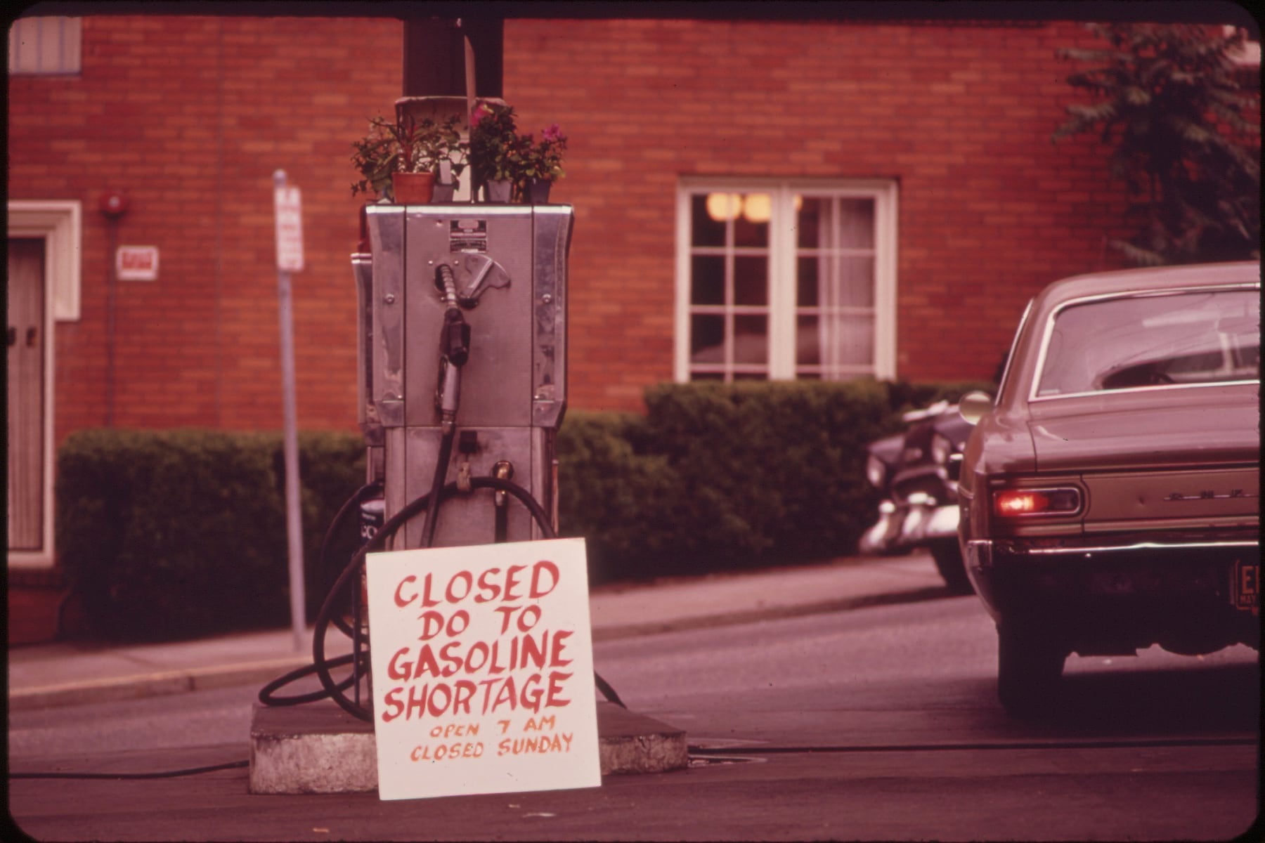 A petrol pump closed in 1973, with a hand-lettered sign announcing the fuel shortage