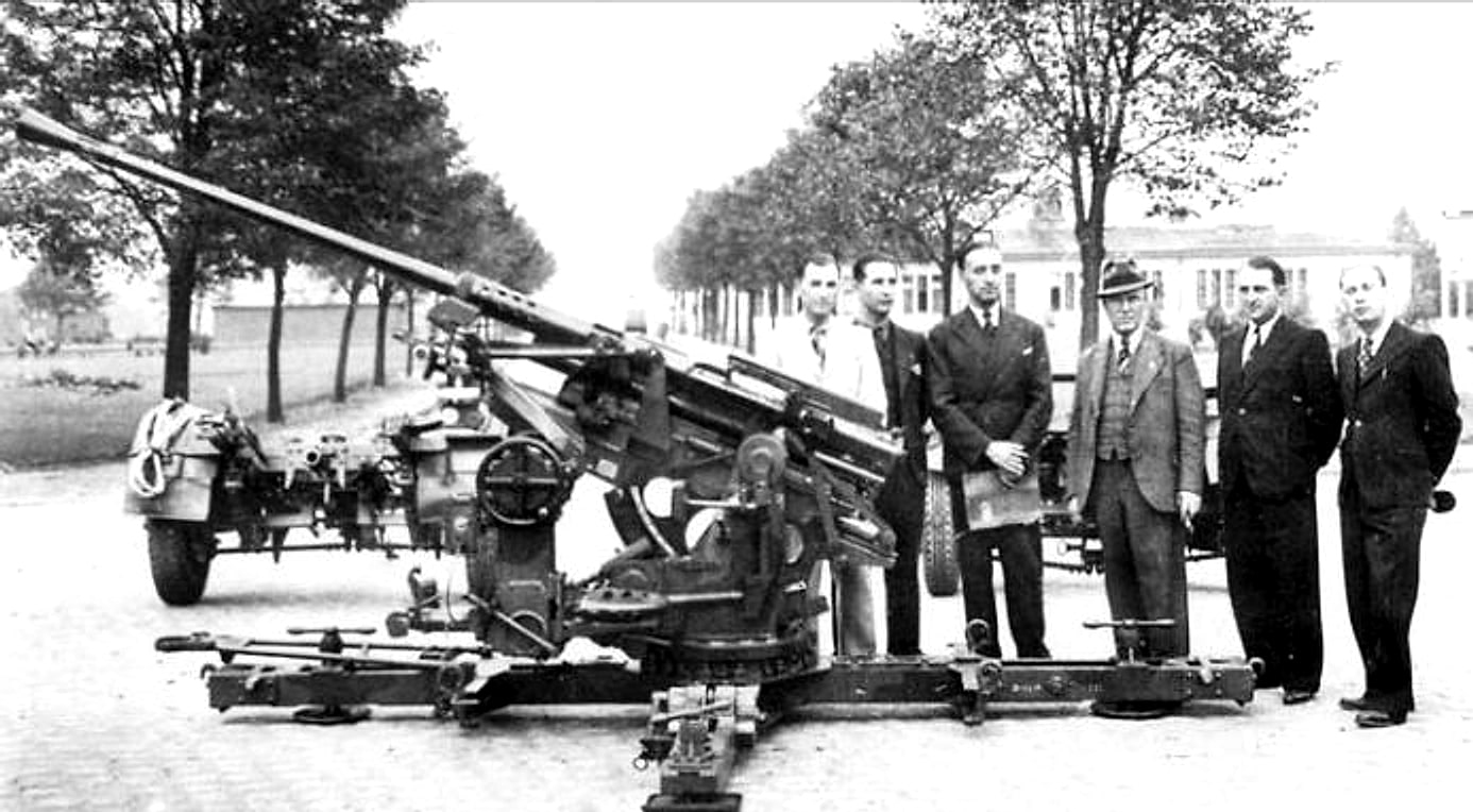 A Rheinmetall 37-millimetre anti-aircraft gun photographed in front of a group of men in suits and hats
